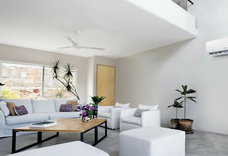 A bedroom with a compact wall-mounted unit