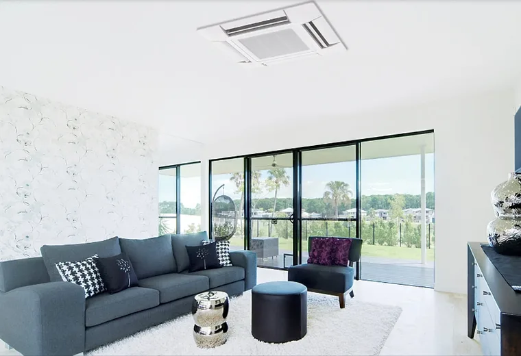 A hand pointing a remote control at a wall unit